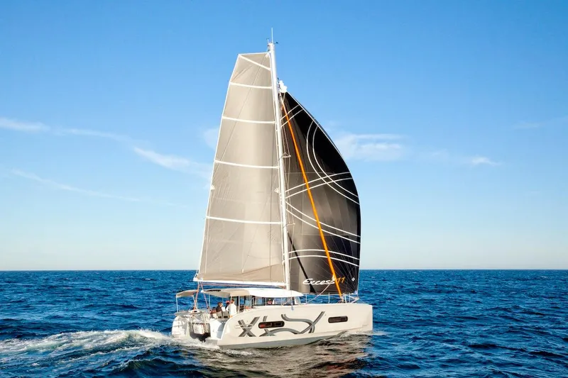  Yacht Photos Pics Sailing catamaran Excess 11, 2026 model, cruising on open sea under clear blue sky.