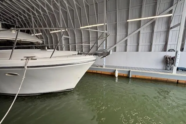 Aqua Billy Yacht Photos Pics A white boat docked in a covered marina with calm water.
