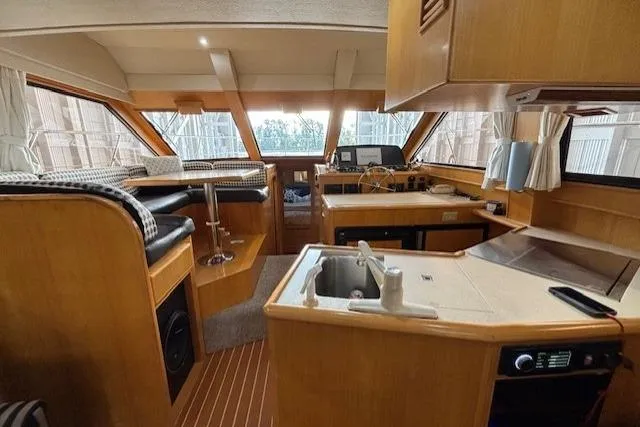 Aqua Billy Yacht Photos Pics Interior of a 1995 Symbol Super Sedan yacht with kitchen and seating area.