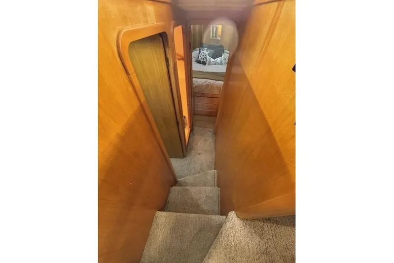 Aqua Billy Yacht Photos Pics Narrow wooden staircase leading to a cozy bedroom in a 1995 Symbol Super Sedan.
