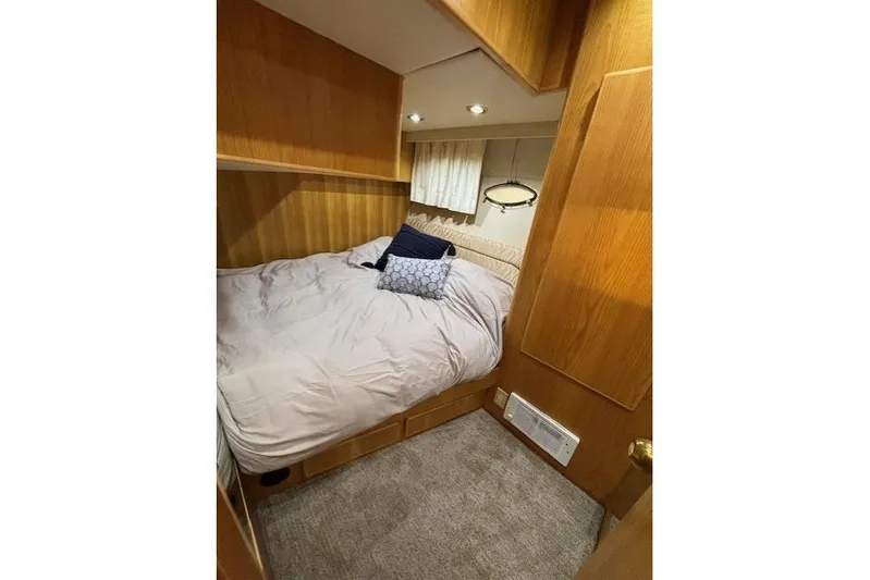 Aqua Billy Yacht Photos Pics Cozy bedroom with wooden paneling, soft lighting, and plush bedding.