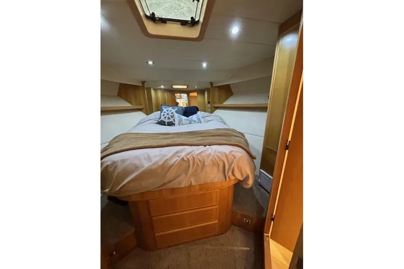 Aqua Billy Yacht Photos Pics Luxurious boat cabin interior with cozy bed and wooden accents, 1995 Symbol Super Sedan.