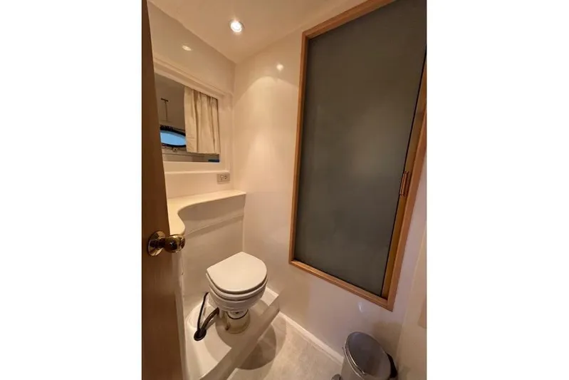 Aqua Billy Yacht Photos Pics Compact bathroom with toilet, frosted window, and minimalistic design in a 1995 Symbol Super Sedan.