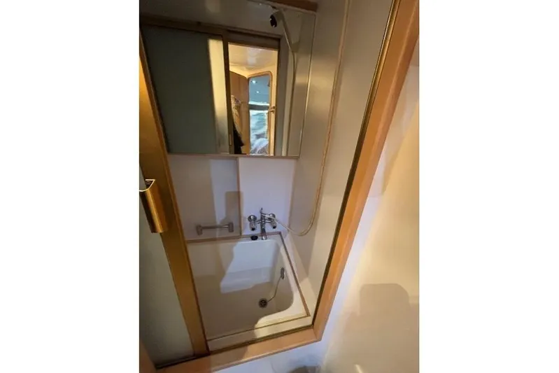 Aqua Billy Yacht Photos Pics Compact bathroom with shower and mirror inside a 1995 Symbol Super Sedan.