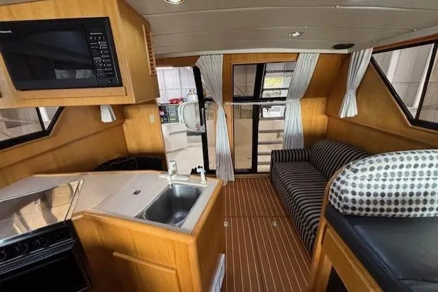 Aqua Billy Yacht Photos Pics Interior of a 1995 Symbol Super Sedan yacht with kitchen and seating area.
