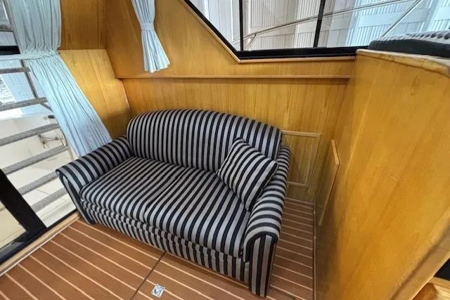 Aqua Billy Yacht Photos Pics Striped sofa in a wooden interior, possibly inside a 1995 Symbol Super Sedan.