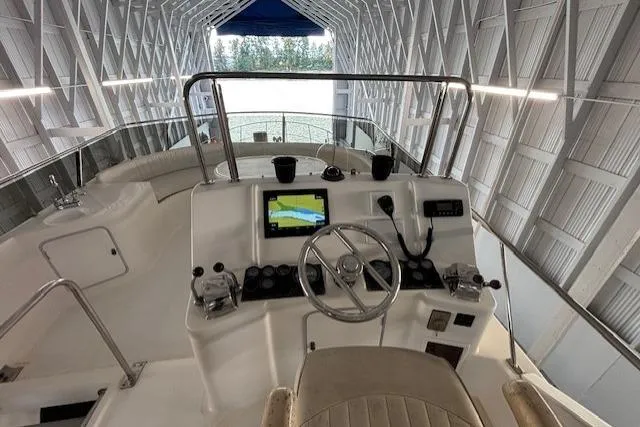 Aqua Billy Yacht Photos Pics Interior view of a boat's helm with steering wheel and navigation screen.