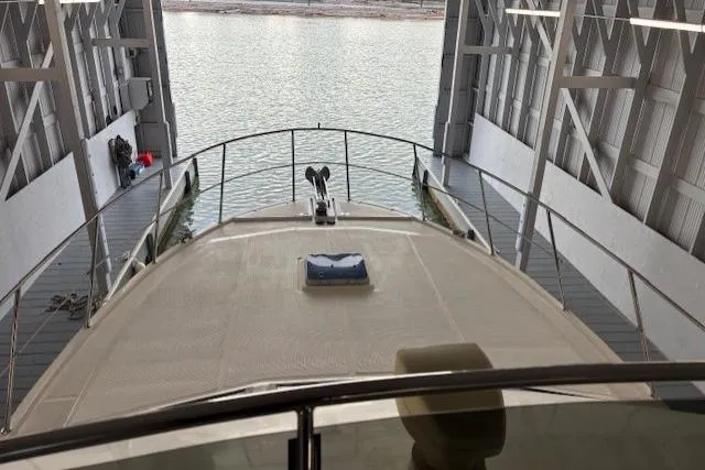 Aqua Billy Yacht Photos Pics View from a boat docked in a covered marina, overlooking calm water.