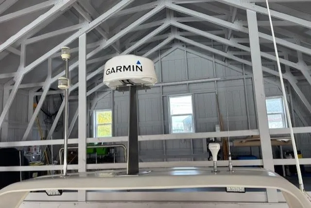 Aqua Billy Yacht Photos Pics Garmin radar system inside a wooden garage with exposed beams.