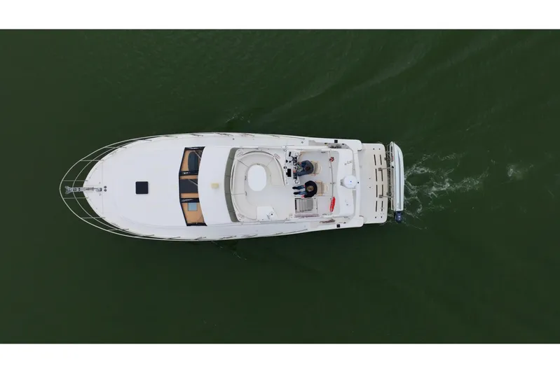 Aqua Billy Yacht Photos Pics Aerial view of a luxury yacht cruising on green water.