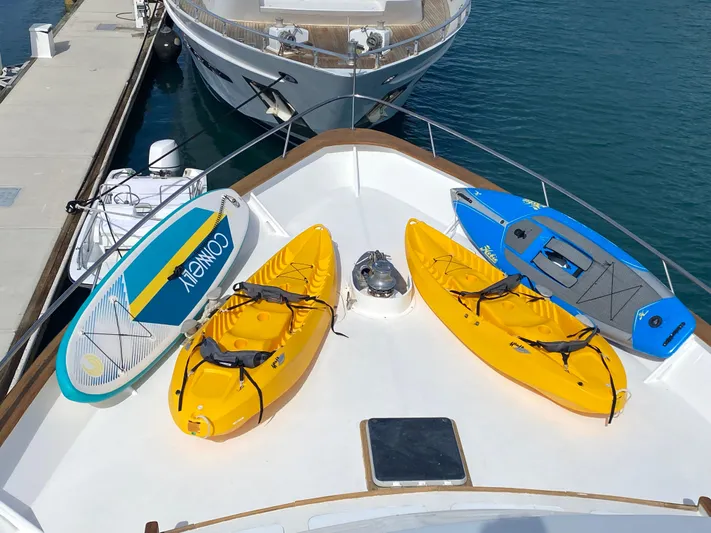Mi Amor Yacht Photos Pics Bow of 1984 DeFever 120 yacht with kayaks and paddleboards docked at marina.