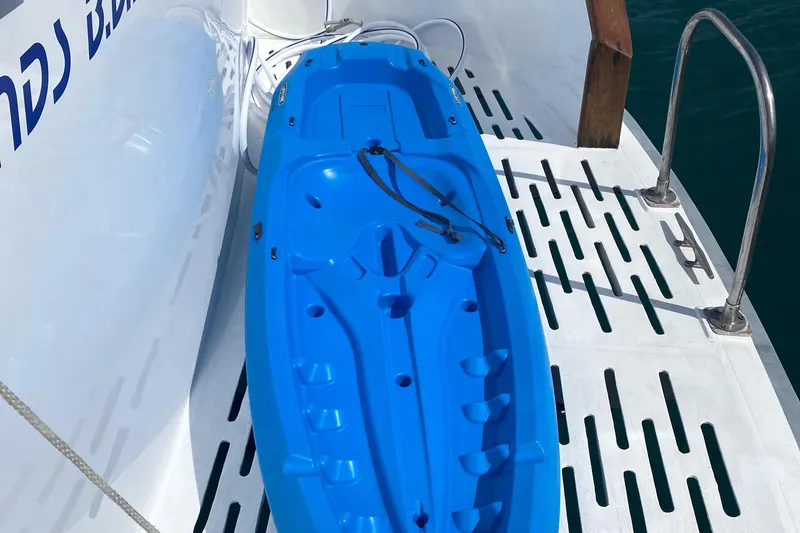 Mi Amor Yacht Photos Pics Blue kayak on DeFever 120 yacht deck, 1984 model, near water.