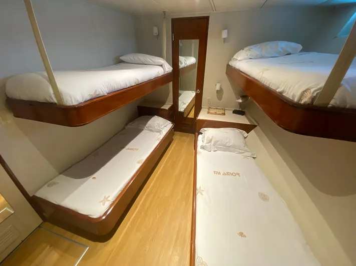 Mi Amor Yacht Photos Pics 1984 DeFever 120 yacht cabin with four cozy bunk beds and wooden flooring.