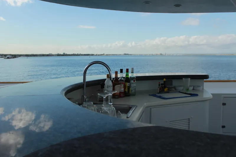 Mi Amor Yacht Photos Pics Luxury yacht bar on 1984 DeFever 120, overlooking serene ocean view.