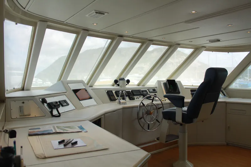 Mi Amor Yacht Photos Pics Bridge interior of 1984 DeFever 120 yacht with navigation equipment and captain's chair.