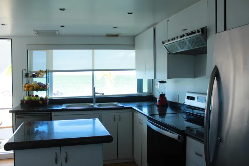 Mi Amor Yacht Photos Pics Modern kitchen interior on a 1984 DeFever 120 yacht with ocean view.