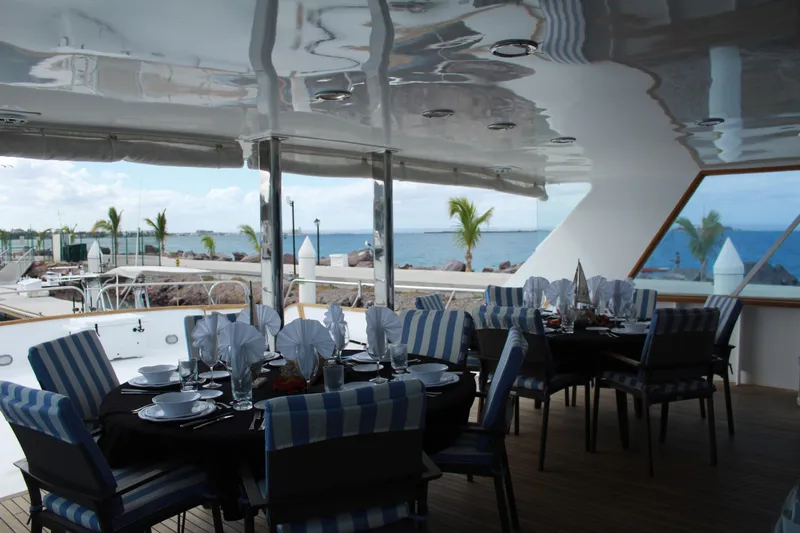 Mi Amor Yacht Photos Pics Elegant dining area on 1984 DeFever 120 yacht with ocean view.