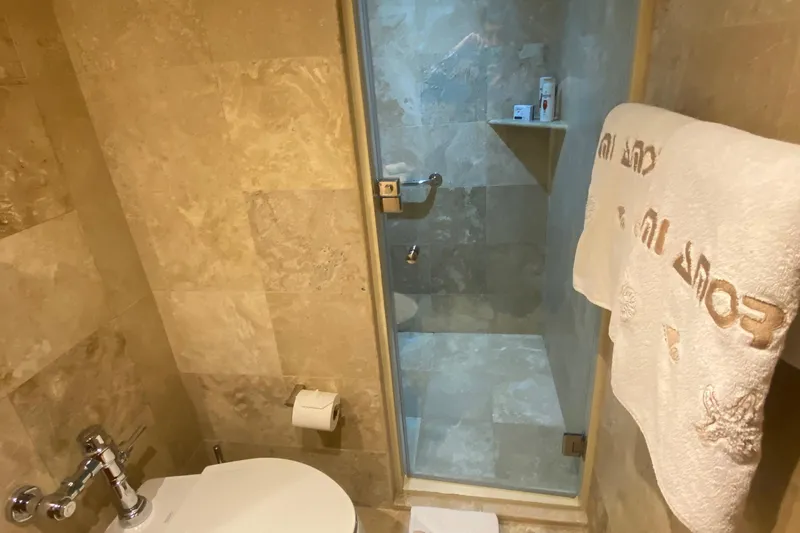 Mi Amor Yacht Photos Pics Luxurious bathroom with tiled shower and towel, aboard 1984 DeFever 120 yacht.