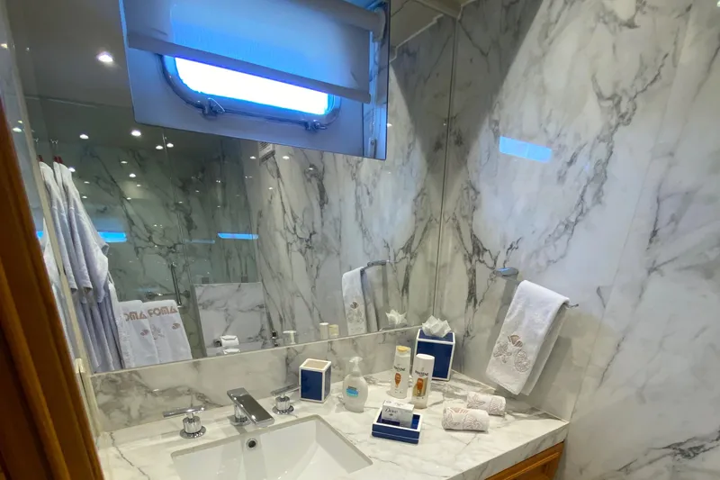 Mi Amor Yacht Photos Pics Luxurious marble bathroom on 1984 DeFever 120 yacht with elegant amenities.