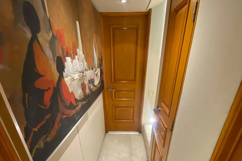 Mi Amor Yacht Photos Pics Hallway in 1984 DeFever 120 yacht with wooden doors and abstract wall art.