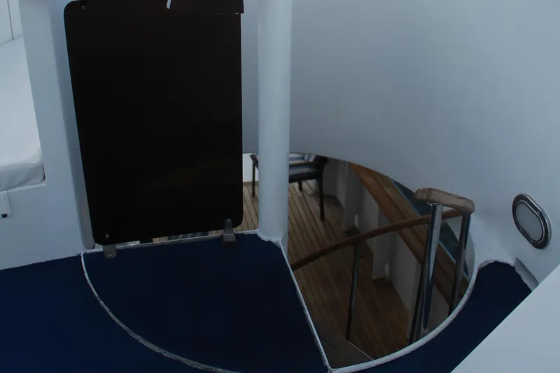 Mi Amor Yacht Photos Pics Staircase on 1984 DeFever 120 yacht, leading to lower deck with wooden flooring.