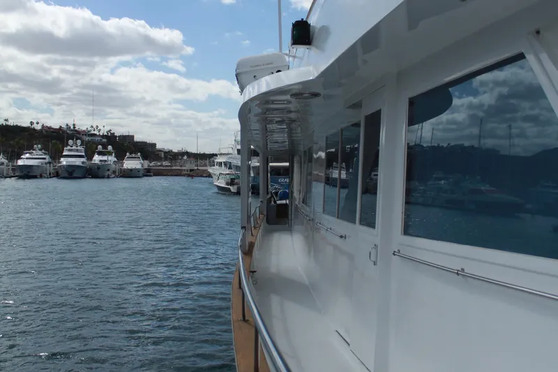 Mi Amor Yacht Photos Pics 1984 DeFever 120 yacht docked in a marina with other boats.