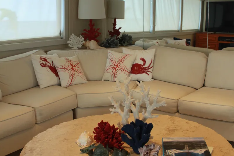 Mi Amor Yacht Photos Pics Luxurious 1984 DeFever 120 yacht interior with nautical-themed decor and plush seating.