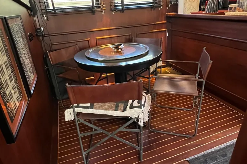  Yacht Photos Pics Elegant wooden interior of 1993 Custom Sailing Yacht Ocean Pure with round table and chairs.