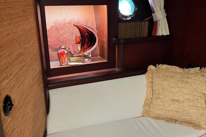  Yacht Photos Pics Cozy cabin interior of 1993 Custom Sailing Yacht Ocean Pure with decorative shelf and porthole.