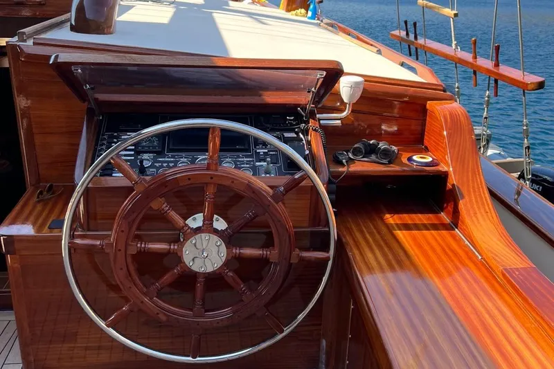  Yacht Photos Pics Wooden helm of the 1993 Custom Sailing Yacht Ocean Pure, featuring nautical instruments.