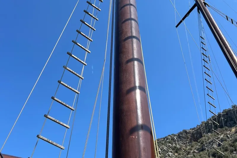  Yacht Photos Pics Tall masts and rigging of Custom Sailing Yacht Ocean Pure, 1993, against clear blue sky.