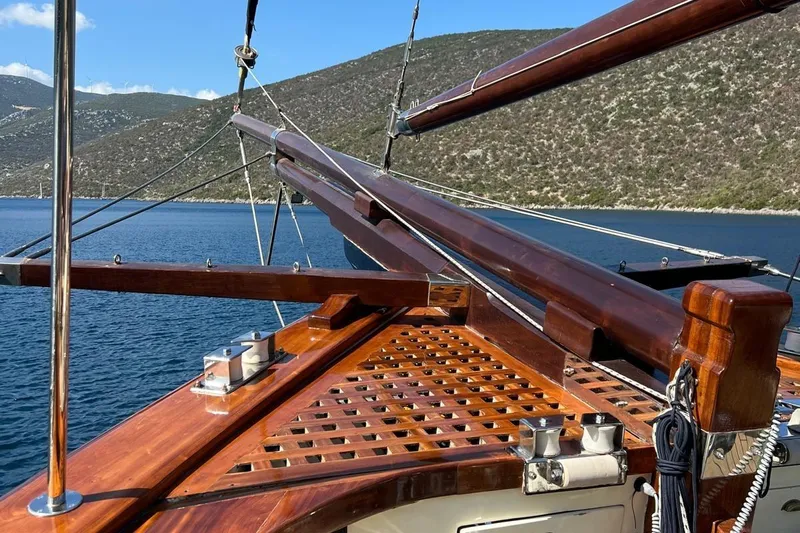  Yacht Photos Pics Custom 1993 Sailing Yacht Ocean Pure with polished wooden deck and scenic coastal backdrop.