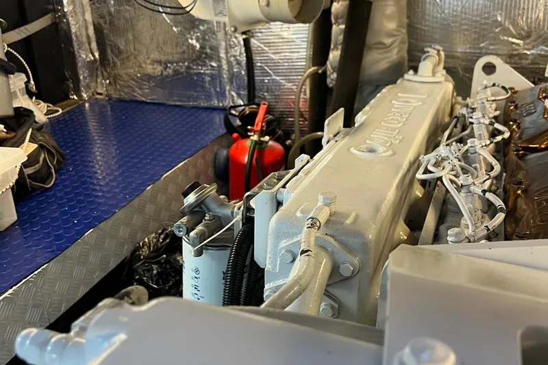  Yacht Photos Pics Engine room of Custom Sailing Yacht Ocean Pure, 1993, featuring mechanical components and fire extinguisher.