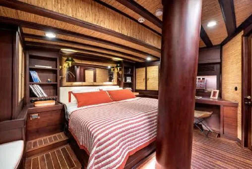  Yacht Photos Pics Luxurious cabin interior of 1993 Custom Sailing Yacht Ocean Pure with wooden decor and cozy bedding.