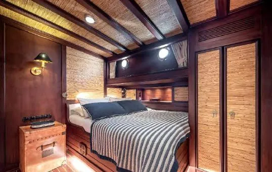  Yacht Photos Pics Luxurious cabin interior of 1993 Custom Sailing Yacht Ocean Pure with wood paneling and cozy bed.