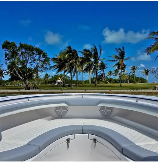  Yacht Photos Pics 2025 Mag Bay 33 boat with scenic tropical background and palm trees.