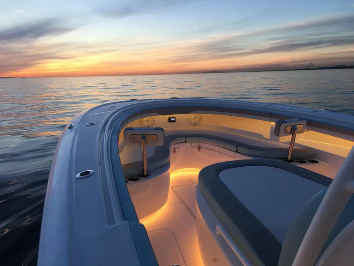  Yacht Photos Pics Mag Bay 33 (2025) boat interior at sunset on calm waters.