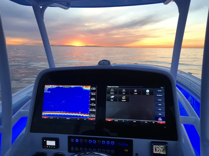  Yacht Photos Pics Mag Bay 33 boat dashboard with navigation screens at sunset, 2025 model.