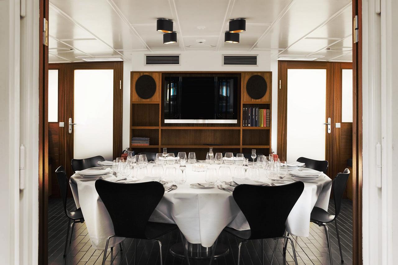 Elegant dining area on 2012 Explorer 35m trawler, featuring a round table and modern decor.