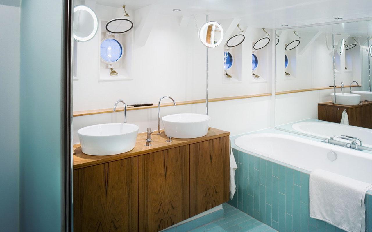 Luxurious bathroom on 2012 Explorer 35m trawler with dual sinks and bathtub.