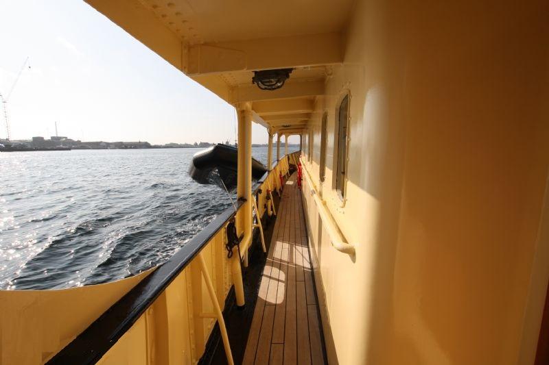 Side deck view of 2012 Explorer 35m trawler, overlooking calm waters.