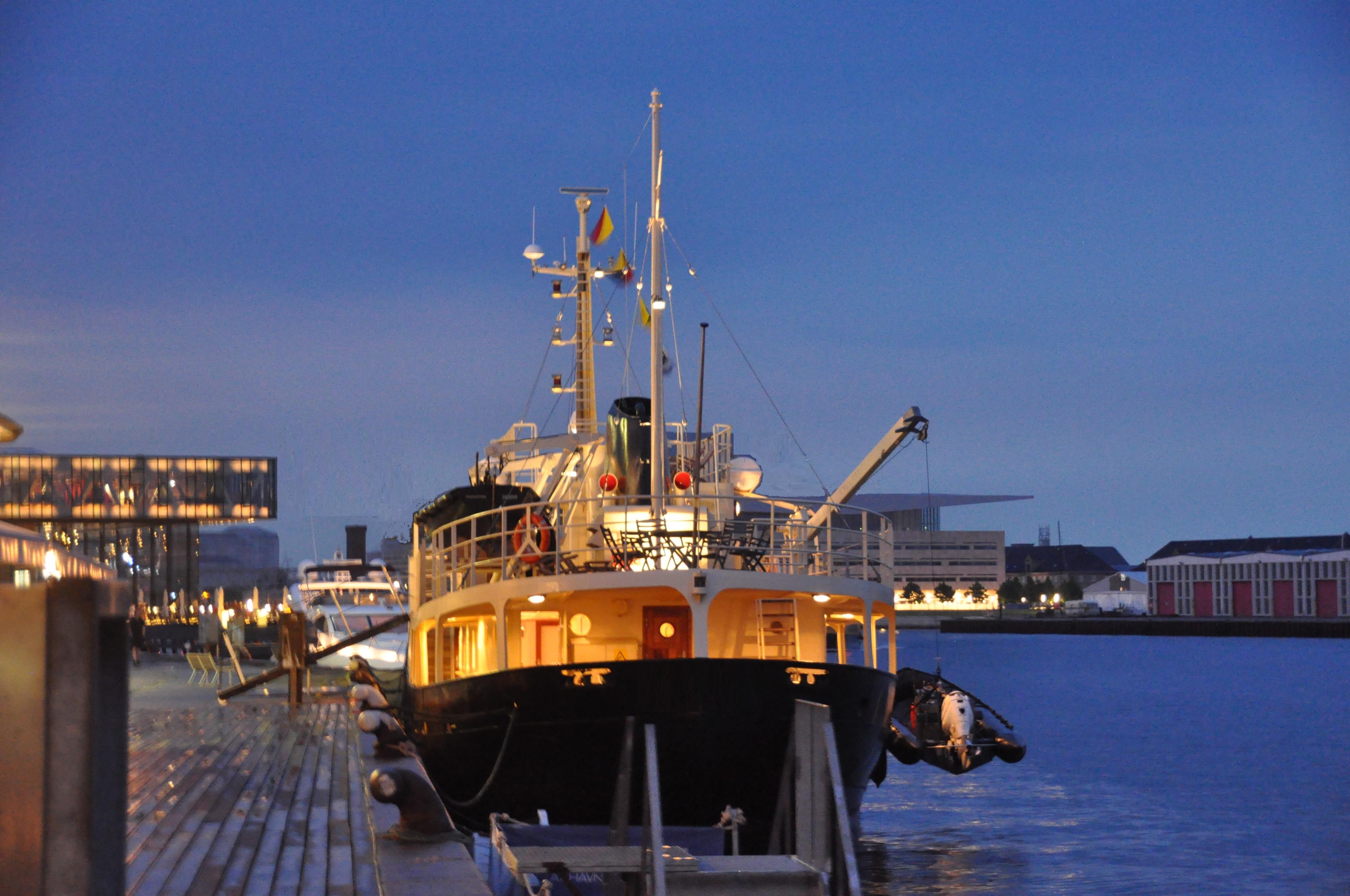 Explorer 35m trawler docked at night, illuminated, 2012 model.
