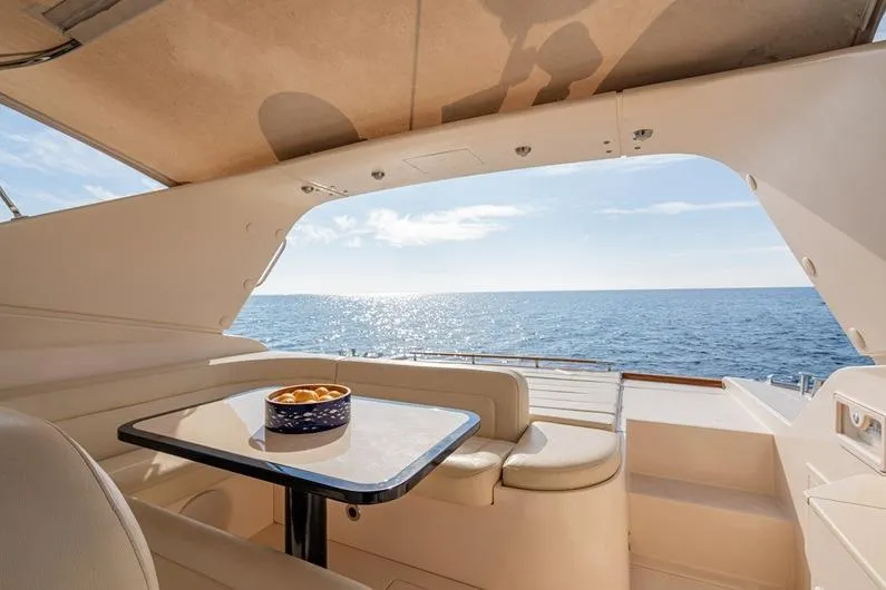  Yacht Photos Pics Luxurious 1996 Riva BAHAMAS 60 SPECIAL yacht interior with ocean view and dining area.