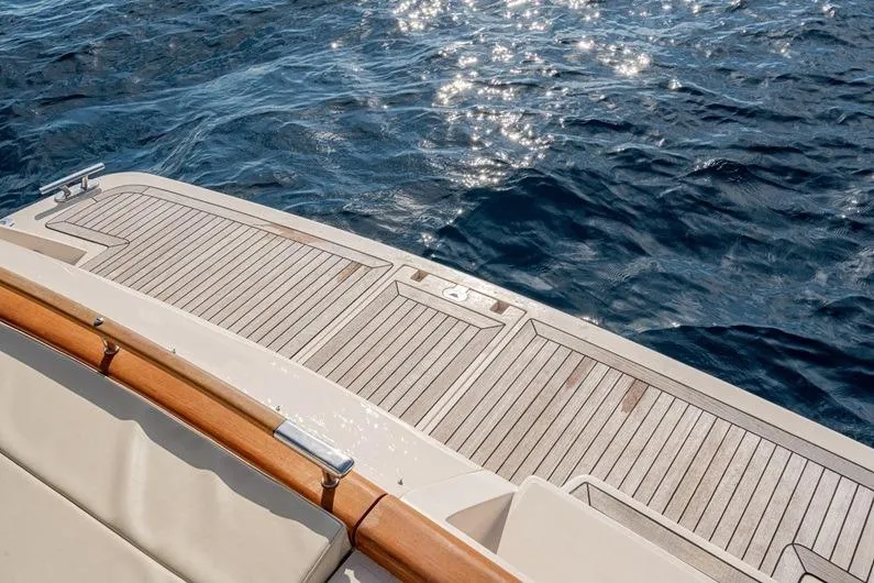  Yacht Photos Pics Riva BAHAMAS 60 SPECIAL 1996 yacht deck with ocean view and sunlight reflections.