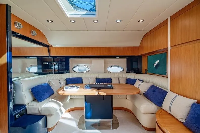  Yacht Photos Pics Luxurious interior of 1996 Riva BAHAMAS 60 SPECIAL yacht with elegant seating and wooden finishes.