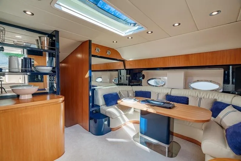  Yacht Photos Pics Luxurious interior of 1996 Riva BAHAMAS 60 SPECIAL yacht with elegant seating and skylight.
