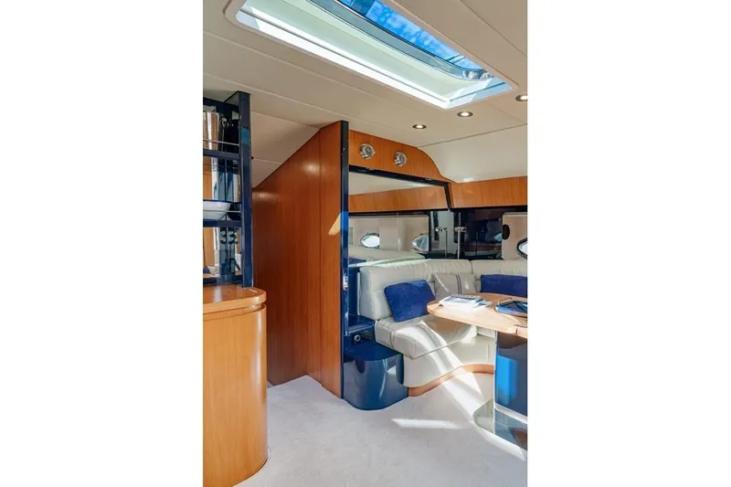  Yacht Photos Pics Luxurious interior of 1996 Riva BAHAMAS 60 SPECIAL yacht with elegant seating and skylight.