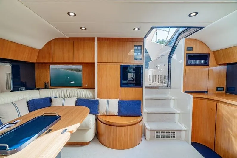  Yacht Photos Pics Luxurious interior of 1996 Riva BAHAMAS 60 SPECIAL yacht with elegant wood finish.
