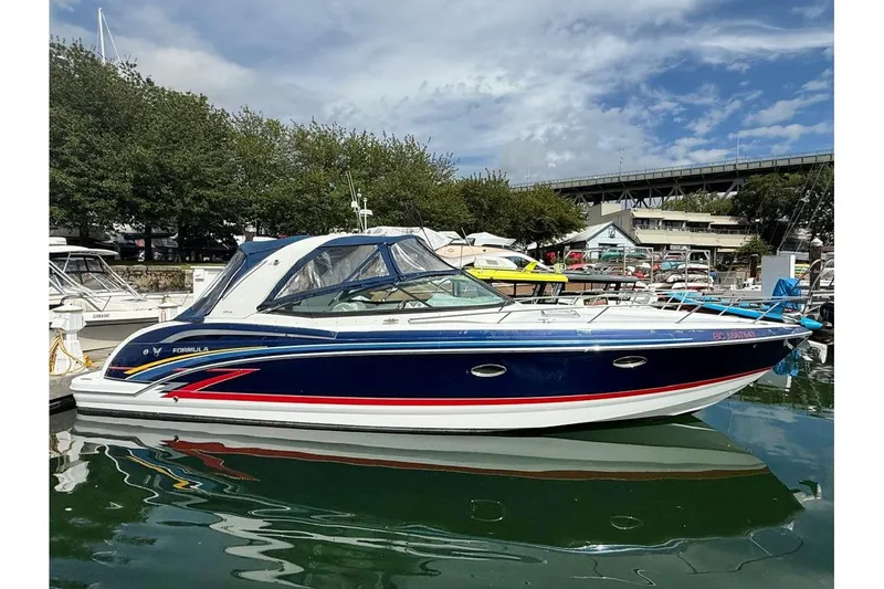  Yacht Photos Pics 2009 Formula 350 Sun Sport boat docked in a marina under a partly cloudy sky.