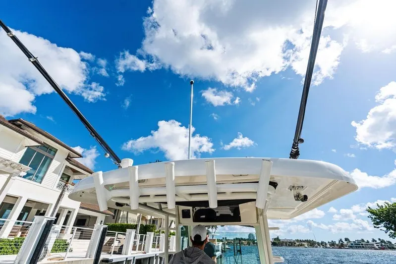 Yacht Photos Pics 2018 Boston Whaler 330 Outrage boat docked under a bright blue sky.